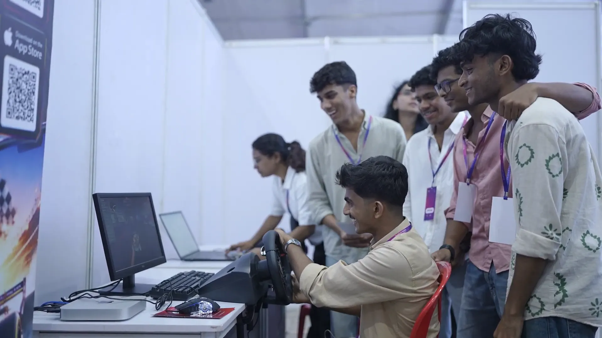Students experiencing Inifinite pro league Revo Racers racing simulator at Revolution Games stall