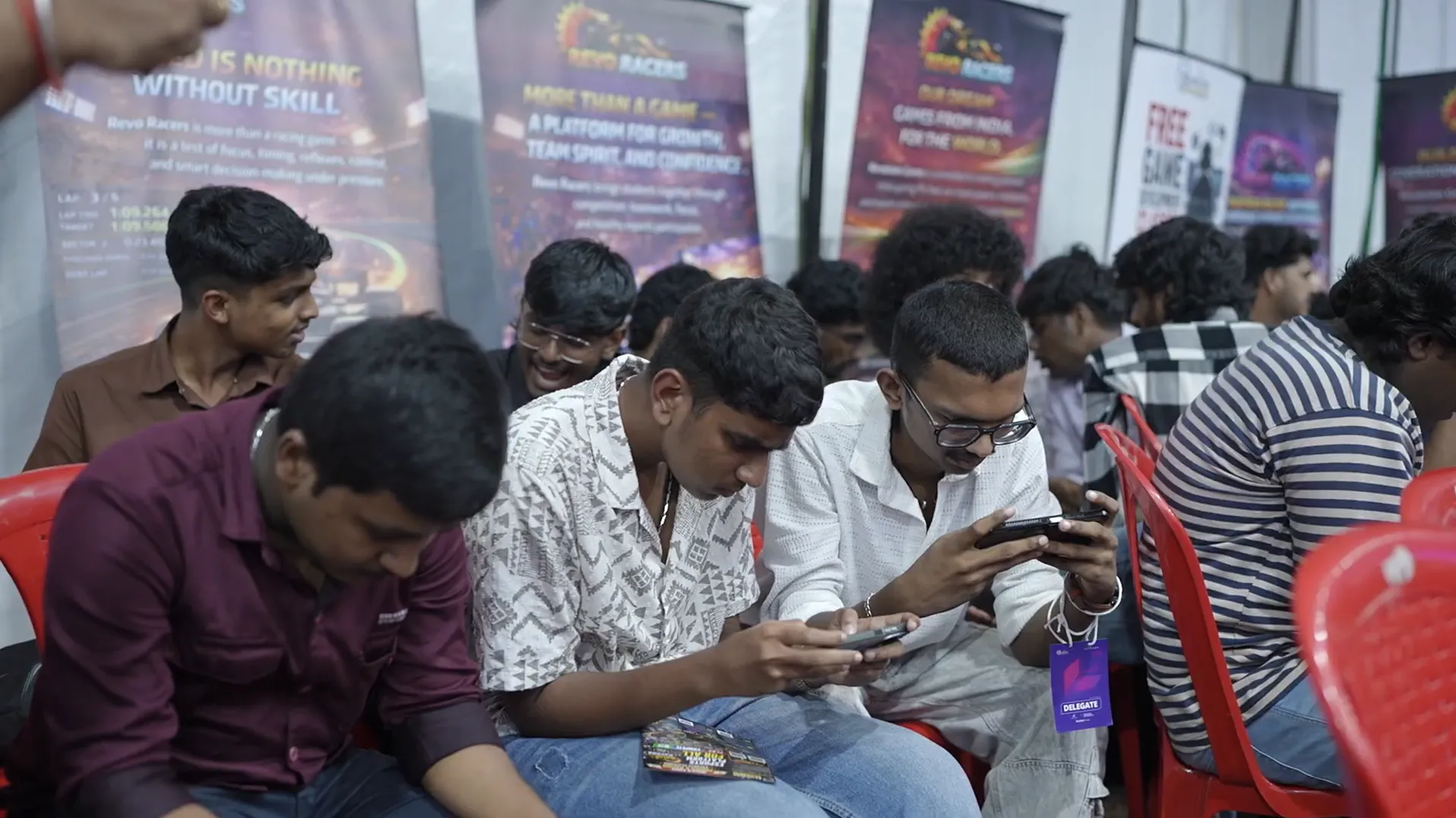 Group of students playing mobile games at Infinite Pro League tournament event